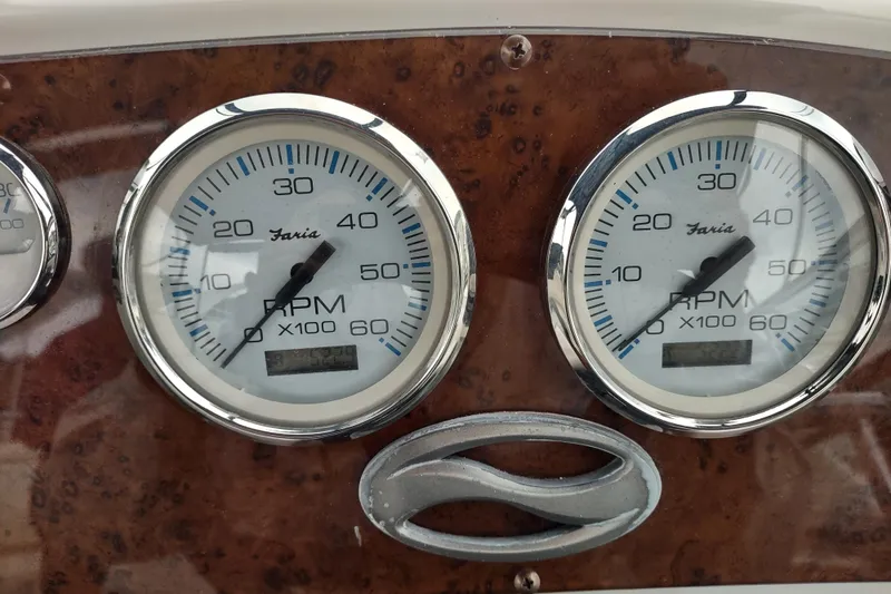 Slide: The Image of Close-up of 2003 Silverton 330 Sport Bridge RPM gauges on a wooden dashboard. - 45