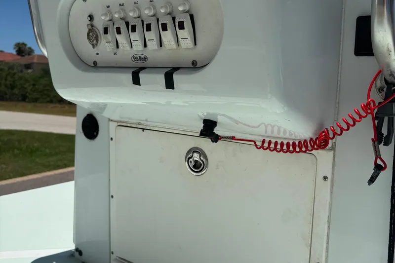Slide: The Image of Control panel of a 2007 NewWater Ibis boat with switches and red safety cord. - 10