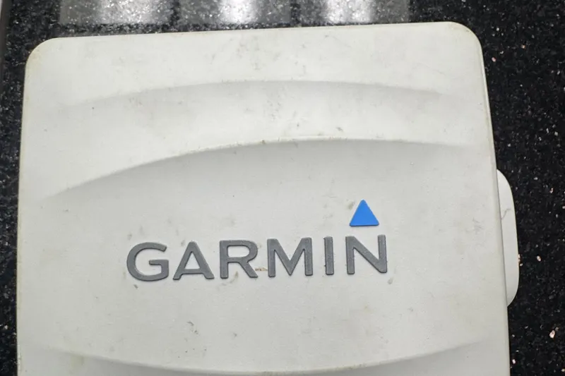 Slide: The Image of White Garmin device on black speckled surface, NewWater Ibis 2007 model. - 16