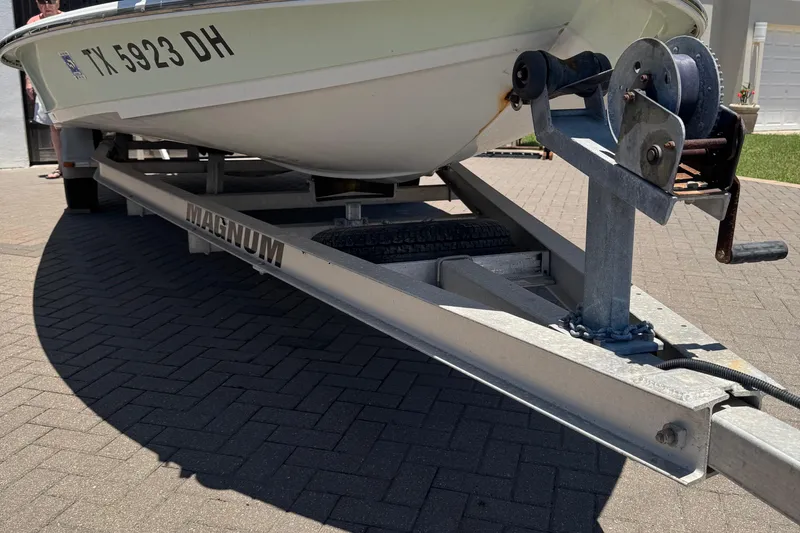 Slide: The Image of Boat on Magnum trailer, NewWater Ibis 2007 model, parked on brick driveway. - 4