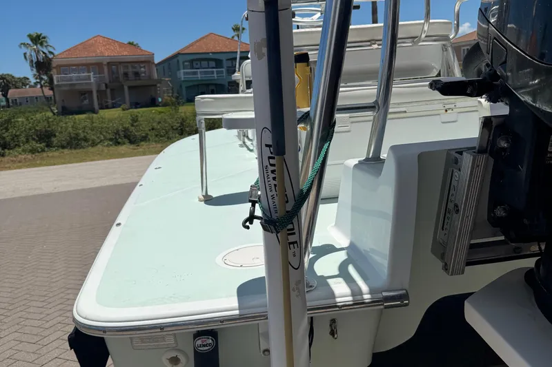 Slide: The Image of NewWater Ibis 2007 boat with shallow water anchor, docked near waterfront homes. - 5
