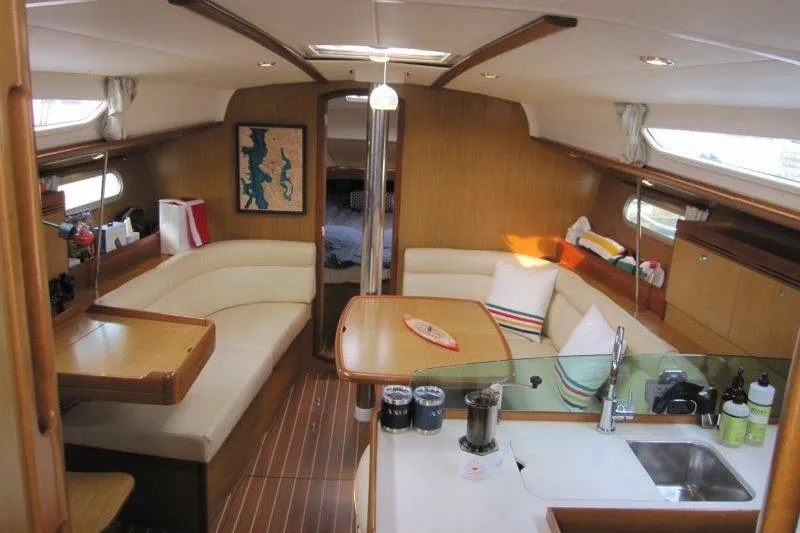 Slide: The Image of Interior of 2008 Jeanneau Sun Odyssey 39i yacht with cozy seating and modern kitchen. - 1