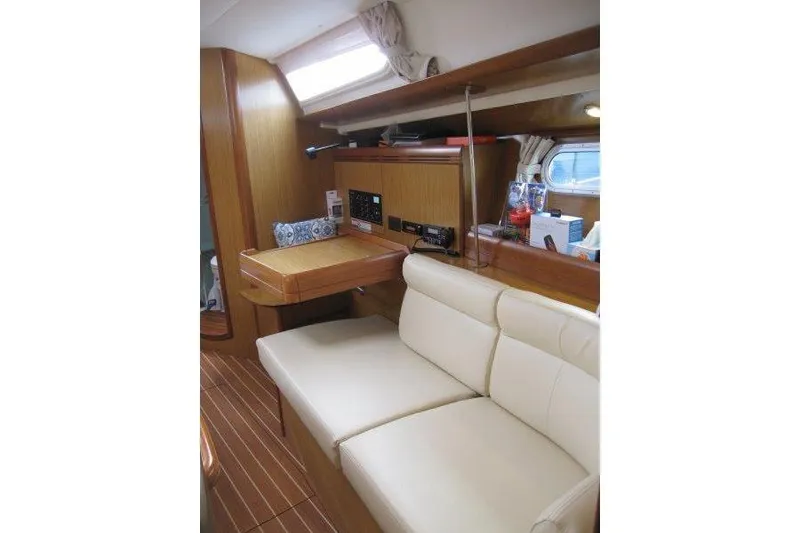 Slide: The Image of Interior of 2008 Jeanneau Sun Odyssey 39i yacht with beige seating and navigation station. - 11