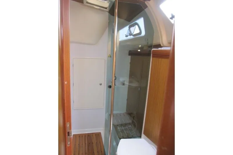 Slide: The Image of Interior of 2008 Jeanneau Sun Odyssey 39i yacht bathroom with wooden accents and glass door. - 16