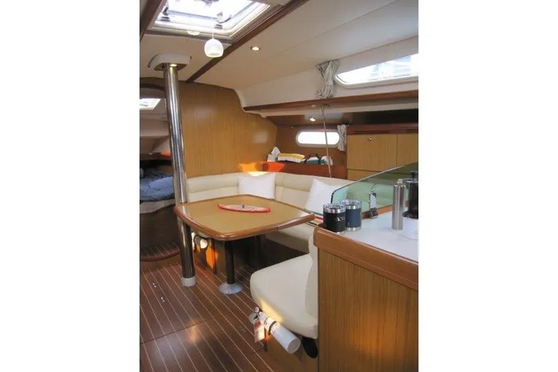 Slide: The Image of Interior of 2008 Jeanneau Sun Odyssey 39i sailboat with cozy seating and wooden finishes. - 19