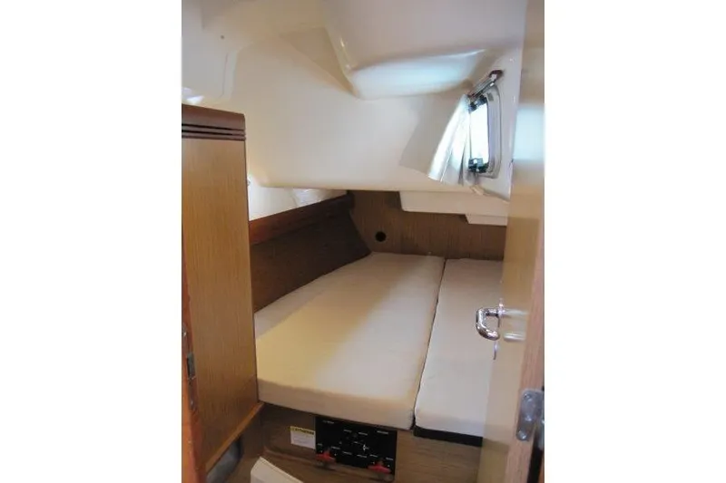 Slide: The Image of 2008 Jeanneau Sun Odyssey 39i cabin interior with cozy bed and wooden accents. - 22