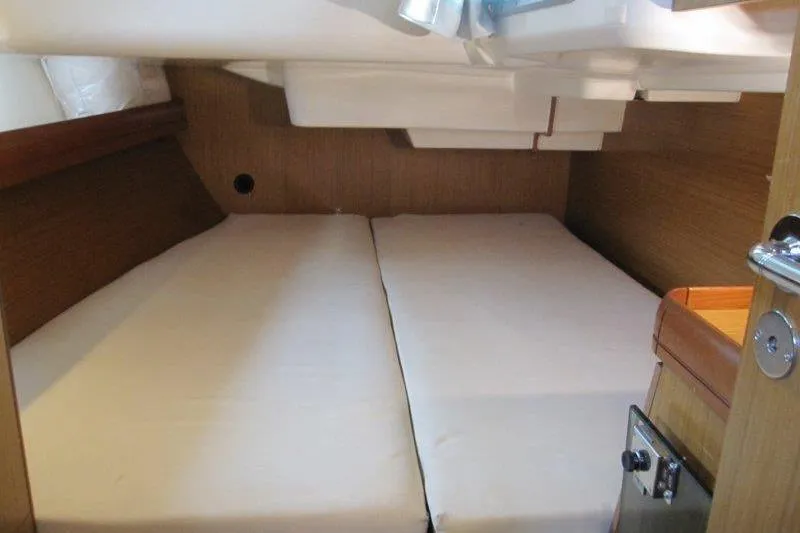 Slide: The Image of 2008 Jeanneau Sun Odyssey 39i cabin interior with twin beds and wooden finish. - 23