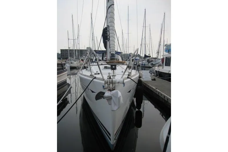 Slide: The Image of 2008 Jeanneau Sun Odyssey 39i sailboat docked in a marina, front view. - 33