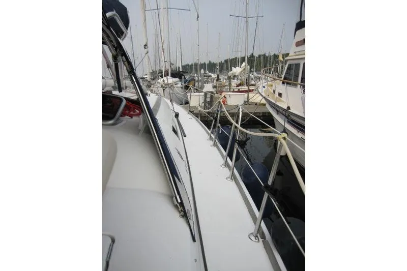 Slide: The Image of 2008 Jeanneau Sun Odyssey 39i sailboat docked in a marina, side deck view. - 41