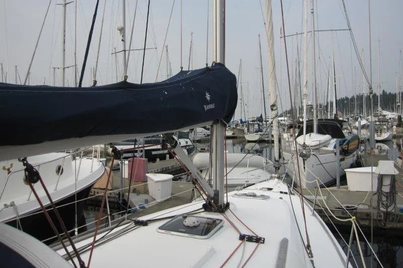 Slide: The Image of 2008 Jeanneau Sun Odyssey 39i sailboat docked in a marina, surrounded by other boats. - 42