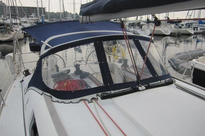 Slide: The Image of 2008 Jeanneau Sun Odyssey 39i sailboat docked in marina, featuring cockpit and canopy. - 43