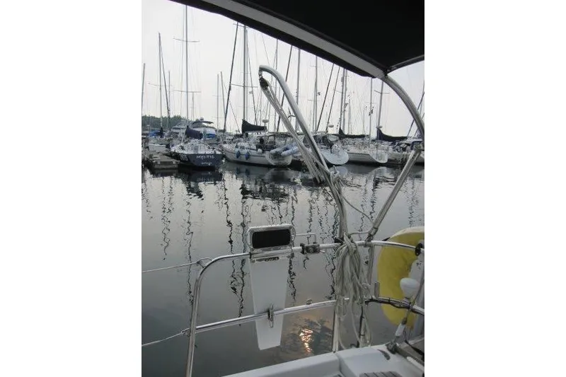 Slide: The Image of 2008 Jeanneau Sun Odyssey 39i sailboat docked in a marina with other boats. - 49