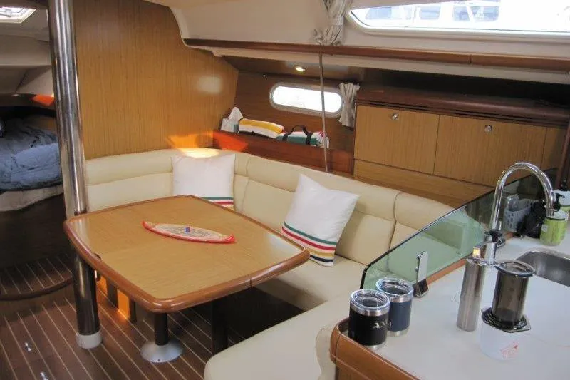 Slide: The Image of Interior of 2008 Jeanneau Sun Odyssey 39i sailboat with cozy seating and kitchenette. - 5