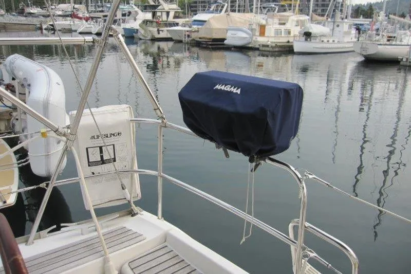 Slide: The Image of 2008 Jeanneau Sun Odyssey 39i yacht with Magma grill, docked in marina. - 50