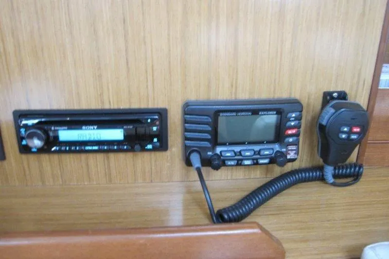 Slide: The Image of Control panel of a 2008 Jeanneau Sun Odyssey 39i yacht with radio and communication equipment. - 8