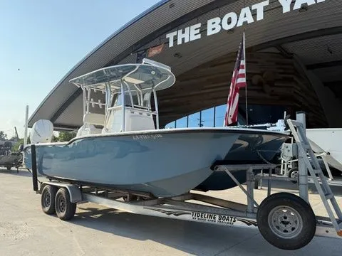 Slide: The Image of 2020 Tideline 235 Hybrid boat on trailer at marina with American flag. - 14