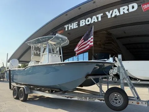 Slide: The Image of 2020 Tideline 235 Hybrid boat on trailer at The Boat Yard, American flag displayed. - 19