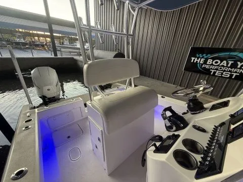 Slide: The Image of 2020 Tideline 235 Hybrid boat interior with modern controls and seating at dock. - 23
