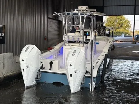 Slide: The Image of 2020 Tideline 235 Hybrid boat with dual engines in a marina setting. - 7