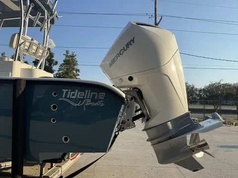 Slide: The Image of 2020 Tideline 235 Hybrid boat with Mercury outboard motor, docked outdoors. - 9
