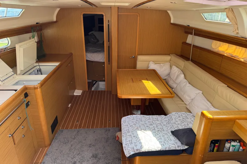 Slide: The Image of Interior of 2009 Jeanneau Sun Odyssey 44i yacht with cozy seating and wooden finishes. - 14