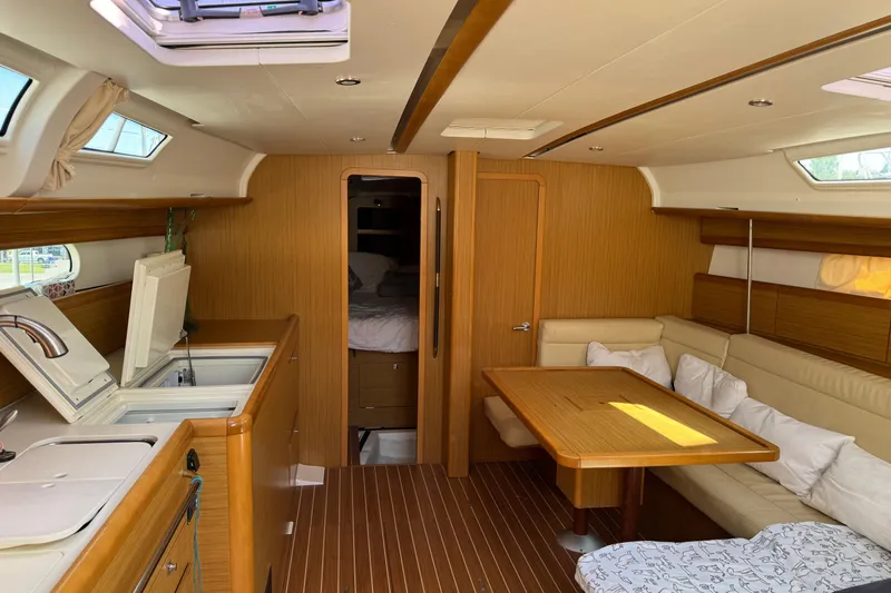 Slide: The Image of Interior of 2009 Jeanneau Sun Odyssey 44i yacht with cozy seating and kitchen area. - 19