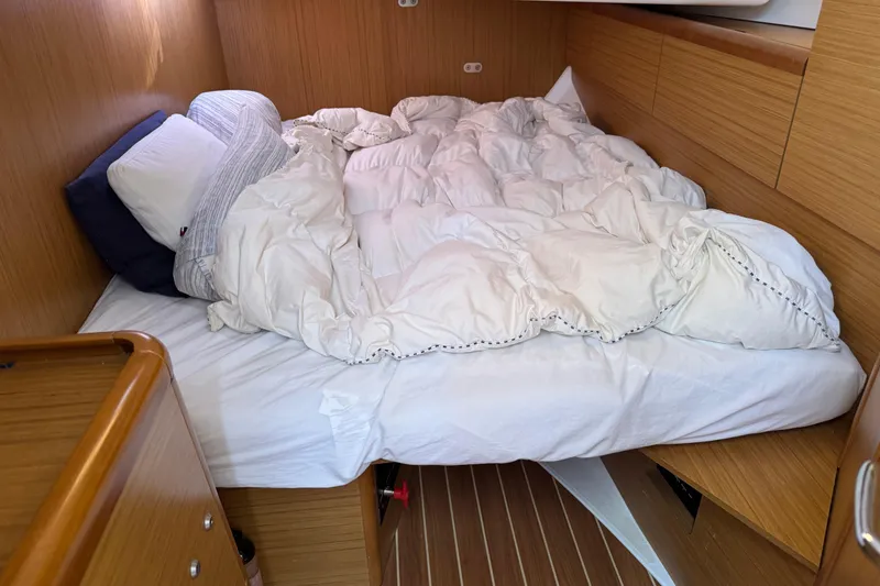 Slide: The Image of Cozy cabin bed in 2009 Jeanneau Sun Odyssey 44i sailboat, featuring wooden interior. - 26