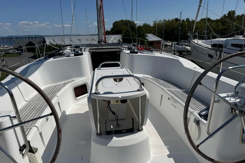 Slide: The Image of 2009 Jeanneau Sun Odyssey 44i sailboat cockpit with dual steering wheels and seating. - 7