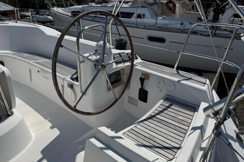 Slide: The Image of Cockpit of 2009 Jeanneau Sun Odyssey 44i sailboat with steering wheel and seating. - 8