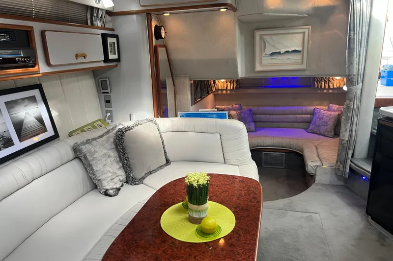 Slide: The Image of Luxurious interior of a 1990 Sea Ray 350 Sundancer yacht with elegant seating and decor. - 12
