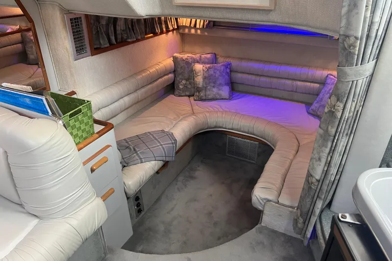 Slide: The Image of Cozy interior of 1990 Sea Ray 350 Sundancer with plush seating and ambient lighting. - 13