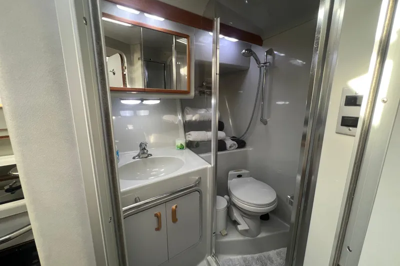 Slide: The Image of 1990 Sea Ray 350 Sundancer bathroom with sink, mirror, shower, and toilet. - 16