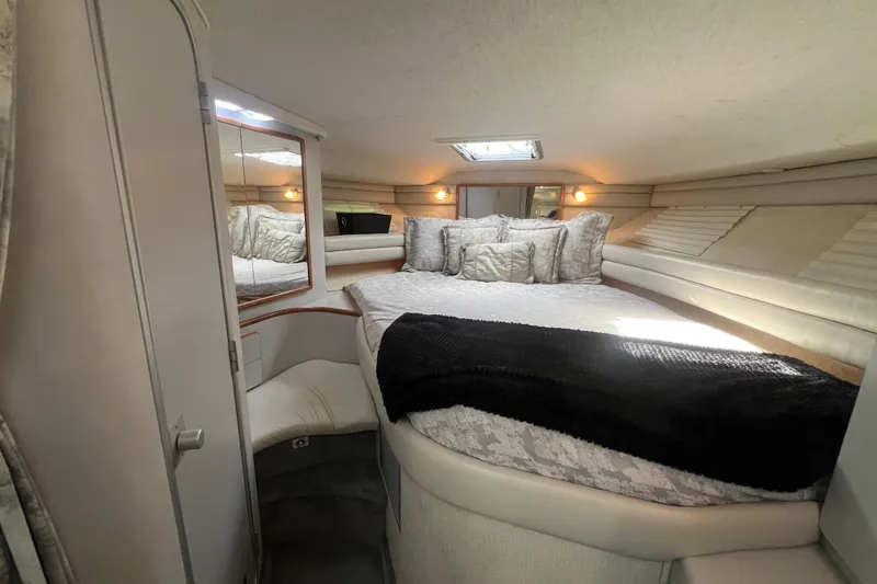 Slide: The Image of Luxurious cabin interior of 1990 Sea Ray 350 Sundancer yacht with cozy bedding. - 18