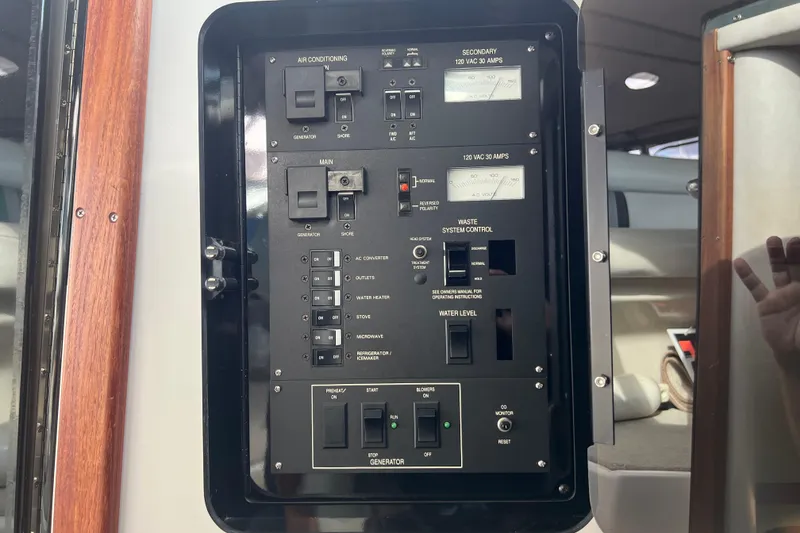 Slide: The Image of Control panel of a 1990 Sea Ray 350 Sundancer boat, featuring various switches and gauges. - 20