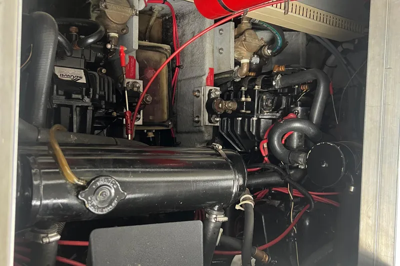 Slide: The Image of Engine compartment of a 1990 Sea Ray 350 Sundancer with visible mechanical components. - 22