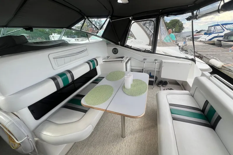 Slide: The Image of Interior of 1990 Sea Ray 350 Sundancer boat with seating and table setup. - 6