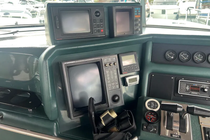 Slide: The Image of Control panel of a 1990 Sea Ray 350 Sundancer with navigation equipment and gauges. - 9