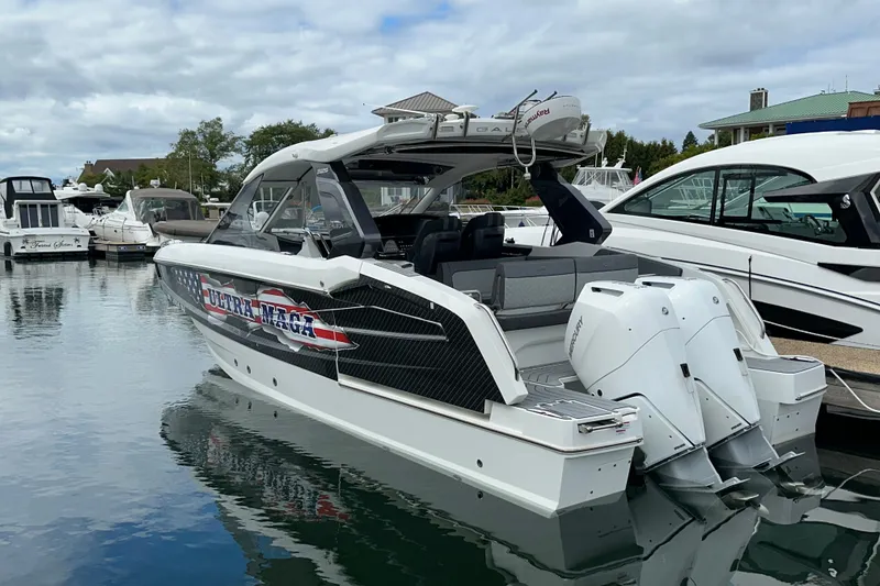 The Image of 2024 Galeon 320 GTO boat docked, featuring sleek design and dual outboard engines. - 1