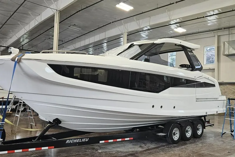 Slide: The Image of 2024 Galeon 325 GTO luxury yacht on trailer in indoor facility. - 11