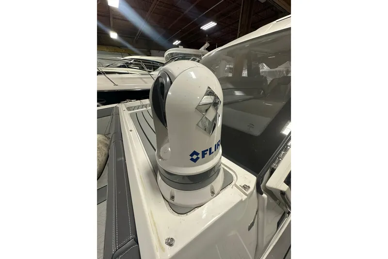 Slide: The Image of 2024 Galeon 325 GTO with FLIR camera system on deck, in a showroom setting. - 6