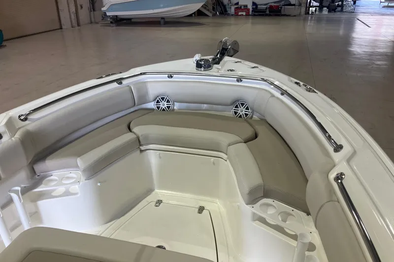 Slide: The Image of 2026 Boston Whaler 230 Outrage boat interior with cushioned seating and cup holders. - 11