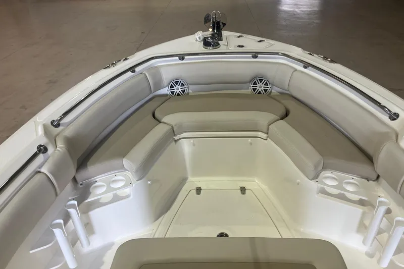 Slide: The Image of 2026 Boston Whaler 230 Outrage boat interior with cushioned seating and cup holders. - 12