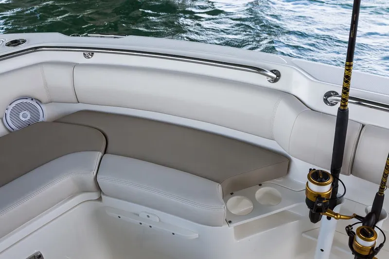 Slide: The Image of Manufacturer Provided Image: 2025 Boston Whaler 230 Outrage boat interior with cushioned seating and fishing rods. - 24