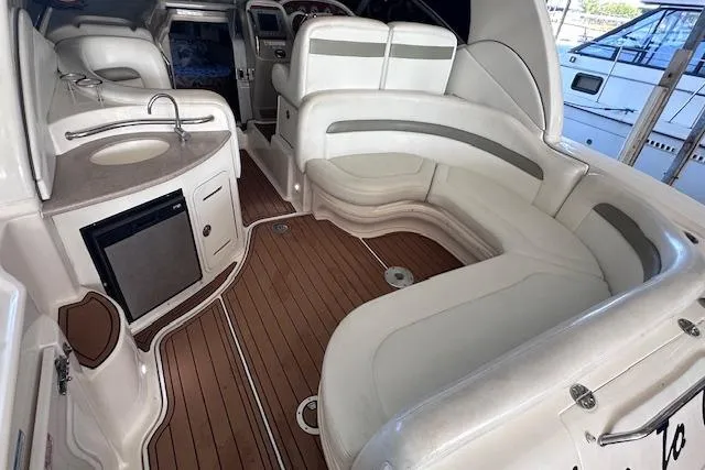 Slide: The Image of 2007 Sea Ray 320 Sundancer interior with white seating and wood flooring. - 17
