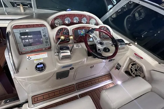 Slide: The Image of 2007 Sea Ray 320 Sundancer helm with gauges, controls, and wood accents. - 18