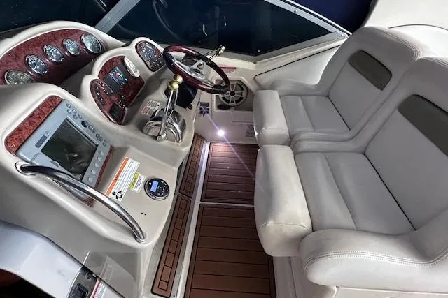 Slide: The Image of 2007 Sea Ray 320 Sundancer cockpit with dual seats, wood accents, and modern controls. - 20