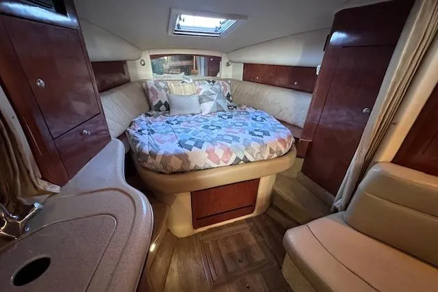 Slide: The Image of 2007 Sea Ray 320 Sundancer cabin with cozy bed and elegant wood finish. - 24