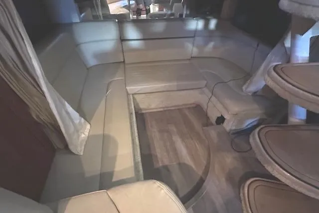 Slide: The Image of Interior of 2007 Sea Ray 320 Sundancer with beige seating and wooden flooring. - 28