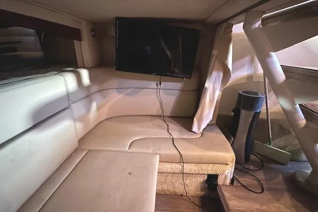 Slide: The Image of Interior of 2007 Sea Ray 320 Sundancer with beige seating and mounted TV. - 30