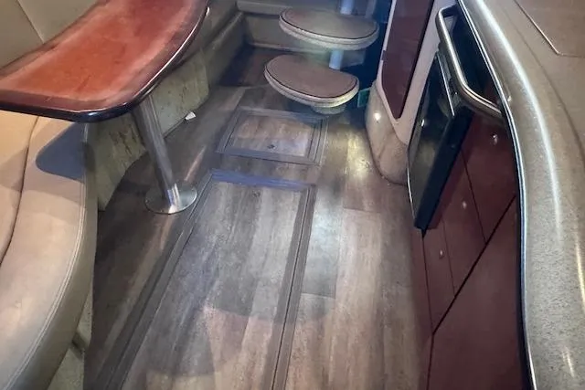 Slide: The Image of Interior of 2007 Sea Ray 320 Sundancer with wood flooring and seating area. - 33